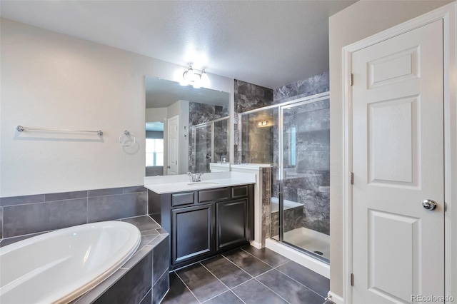 15955 E Otero Cir, Centennial, CO 80112 - full bathroom with a garden tub, vanity, a stall shower, and tile patterned flooring
