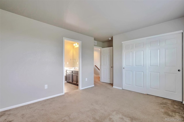 15955 E Otero Cir, Centennial, CO 80112 - unfurnished bedroom with light colored carpet, a closet, and ensuite bath