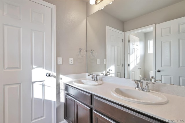 15955 E Otero Cir, Centennial, CO 80112 - bathroom with double vanity and toilet