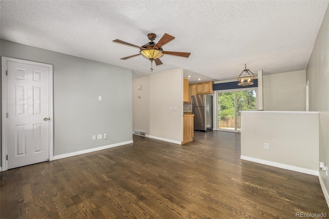 spare room featuring a textured ceiling, ceiling fan, and dark hardwood / wood-style flooring