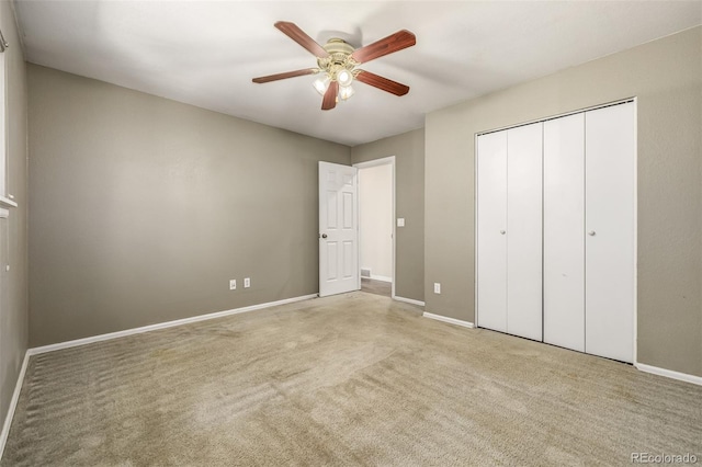 unfurnished bedroom with light colored carpet, ceiling fan, and a closet