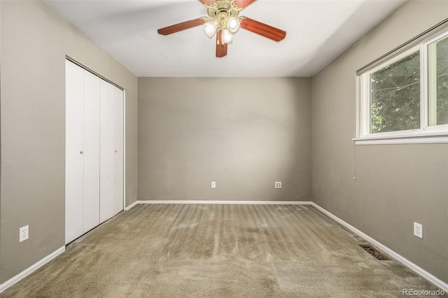 unfurnished bedroom featuring a closet, ceiling fan, and carpet