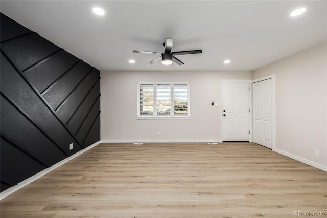 unfurnished room with ceiling fan and light hardwood / wood-style flooring