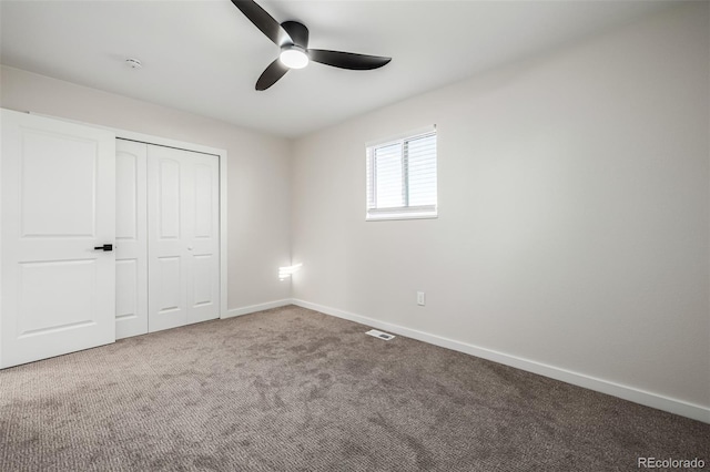 unfurnished bedroom with ceiling fan, a closet, and carpet floors