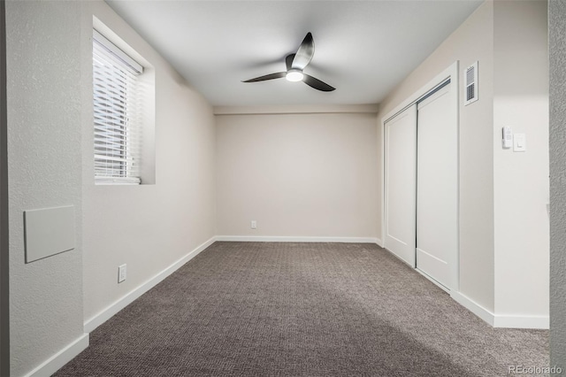 unfurnished bedroom with ceiling fan, a closet, and carpet flooring