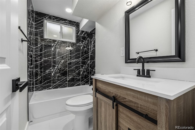 full bathroom featuring toilet, vanity, and tiled shower / bath