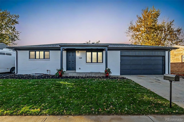 single story home featuring a yard and a garage