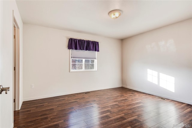 empty room featuring dark hardwood / wood-style flooring