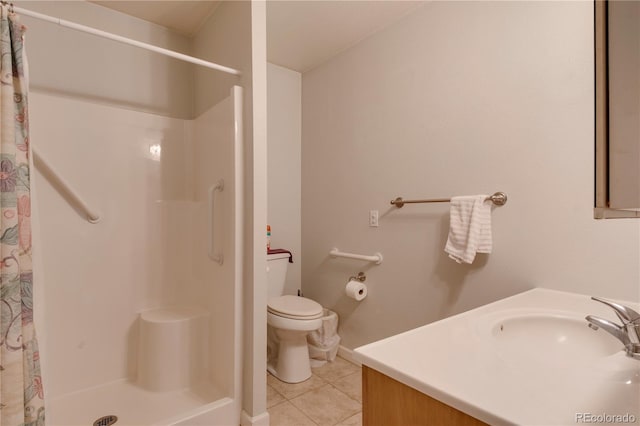 bathroom featuring tile patterned flooring, vanity, curtained shower, and toilet