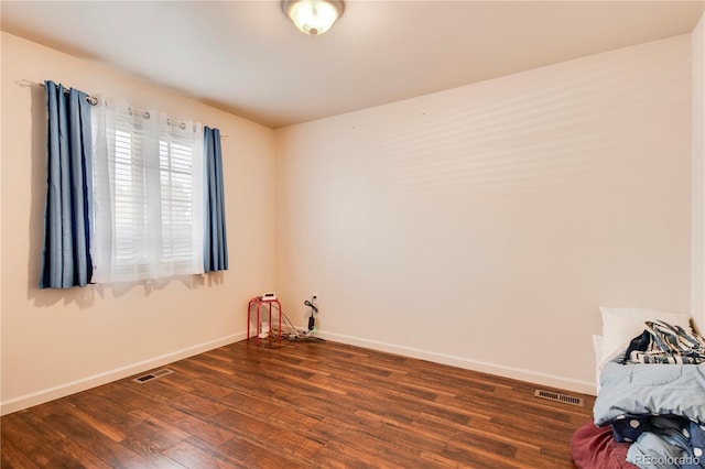 spare room featuring dark wood-type flooring