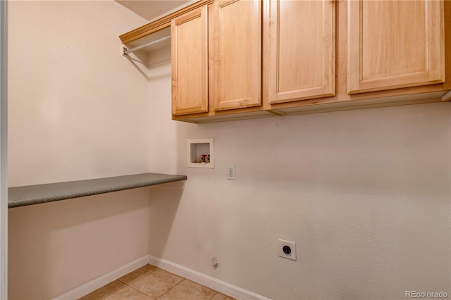 laundry area featuring cabinets, washer hookup, gas dryer hookup, electric dryer hookup, and light tile patterned floors