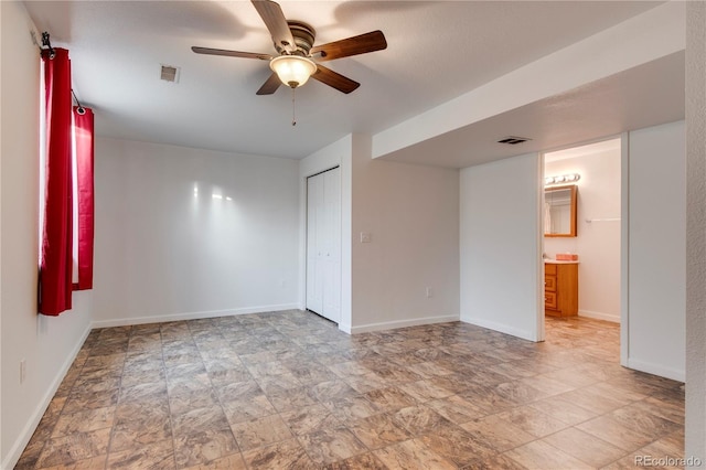 unfurnished room with ceiling fan and a textured ceiling