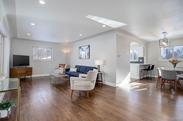 living room with dark hardwood / wood-style flooring