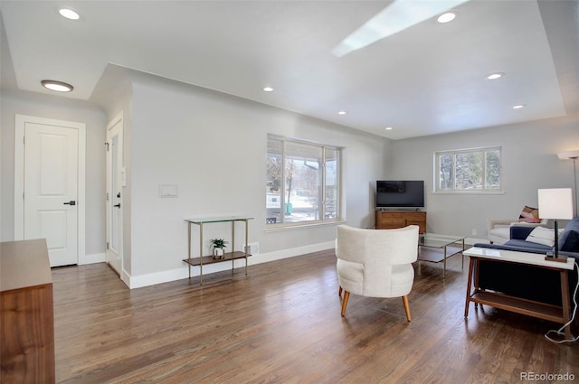 living room featuring dark hardwood / wood-style flooring and a healthy amount of sunlight