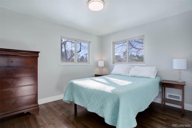 bedroom featuring dark hardwood / wood-style floors and multiple windows