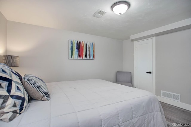 bedroom with wood-type flooring and a closet