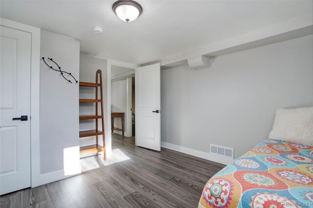 bedroom with dark wood-type flooring