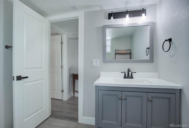 bathroom with vanity and hardwood / wood-style flooring