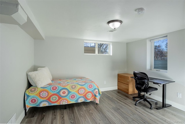 bedroom with light hardwood / wood-style floors