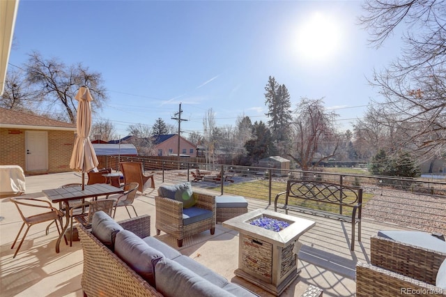 deck with an outdoor living space with a fire pit