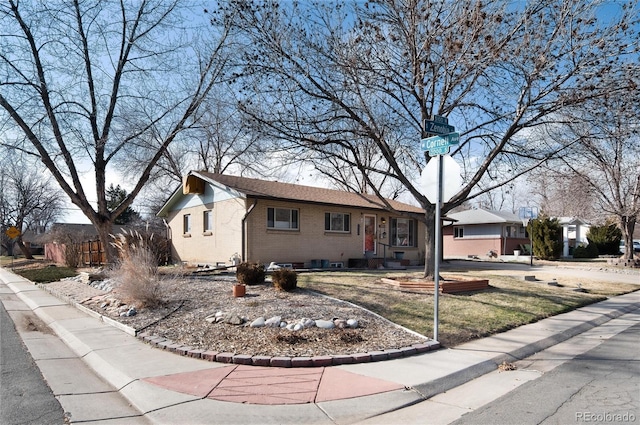 ranch-style house featuring brick siding