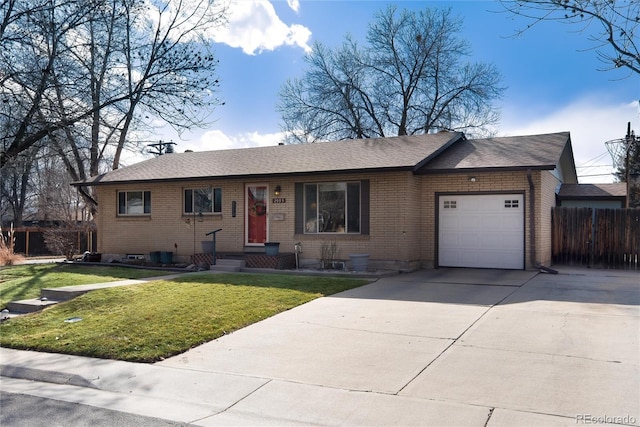 ranch-style house featuring a front yard, fence, driveway, an attached garage, and brick siding