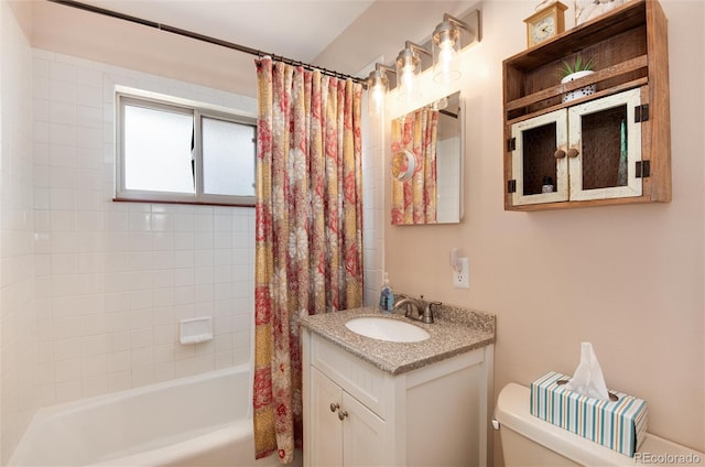 bathroom featuring shower / bath combo with shower curtain, toilet, and vanity