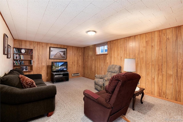 living area with carpet and wood walls