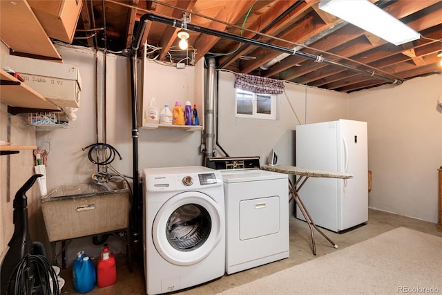 laundry area featuring washer and dryer, laundry area, and a sink