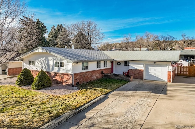 ranch-style home with a garage, driveway, brick siding, and fence