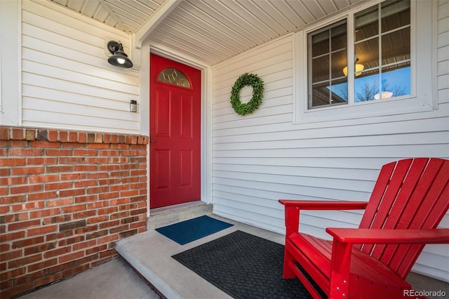 view of exterior entry with brick siding