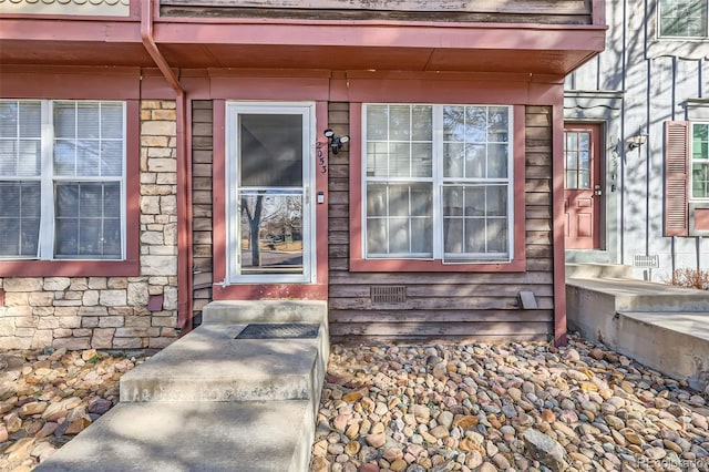 entrance to property with stone siding