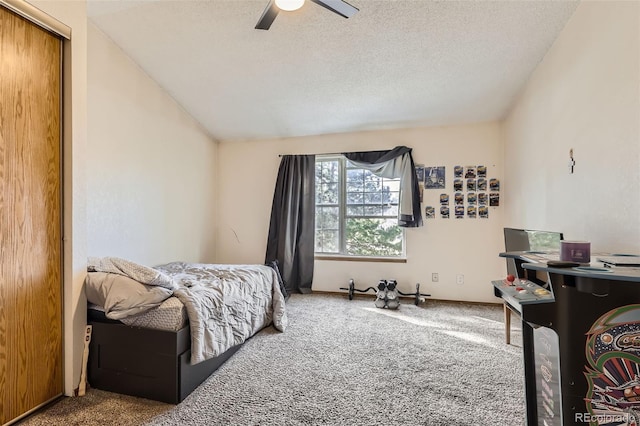 carpeted bedroom with baseboards, a textured ceiling, ceiling fan, and vaulted ceiling