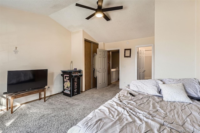 bedroom featuring a textured ceiling, a closet, carpet floors, ceiling fan, and vaulted ceiling