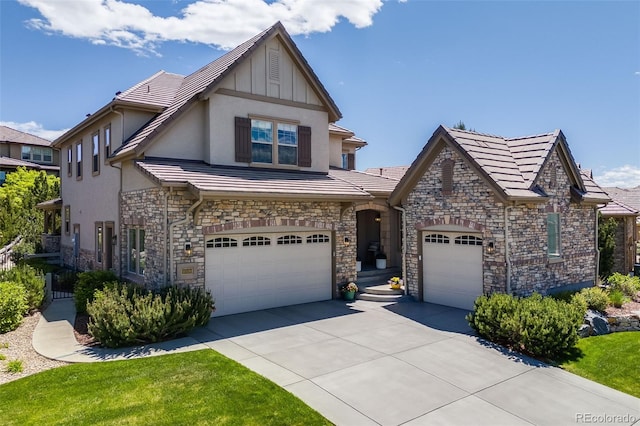 10590 Soulmark Way, Highlands Ranch, CO 80126 - view of front facade featuring driveway, stucco siding, stone siding, and a garage