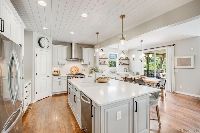 10590 Soulmark Way, Highlands Ranch, CO 80126 - kitchen featuring appliances with stainless steel finishes, wall chimney range hood, a sink, recessed lighting, and open shelves