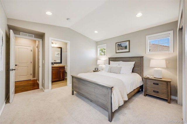 10590 Soulmark Way, Highlands Ranch, CO 80126 - bedroom featuring light carpet, lofted ceiling, baseboards, connected bathroom, and recessed lighting