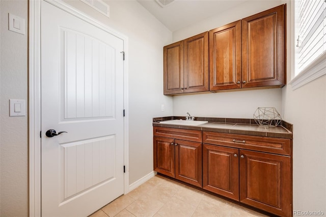 10590 Soulmark Way, Highlands Ranch, CO 80126 - bar featuring a sink, baseboards, and light tile patterned floors