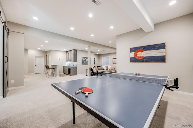10590 Soulmark Way, Highlands Ranch, CO 80126 - rec room featuring light colored carpet, recessed lighting, baseboards, a barn door, and bar area