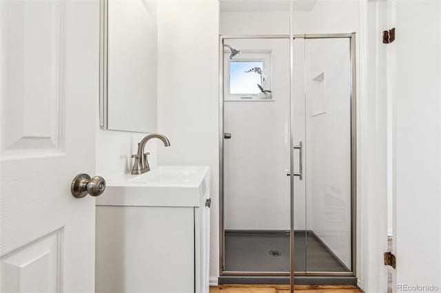 bathroom with a stall shower and vanity