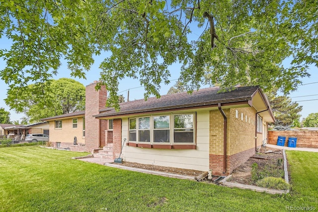 555 W Mansfield Ave, Englewood, CO 80110 - back of house featuring brick siding and a chimney