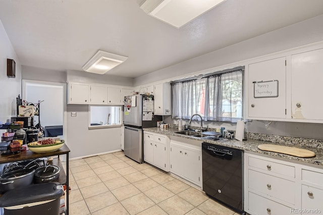 555 W Mansfield Ave, Englewood, CO 80110 - kitchen featuring black dishwasher, a sink, freestanding refrigerator, white cabinetry, and light stone countertops