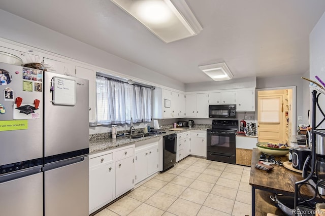 555 W Mansfield Ave, Englewood, CO 80110 - kitchen featuring black appliances, light tile patterned flooring, a sink, white cabinets, and light stone counters