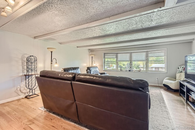 555 W Mansfield Ave, Englewood, CO 80110 - living room with wood finished floors, baseboards, a textured ceiling, and beam ceiling