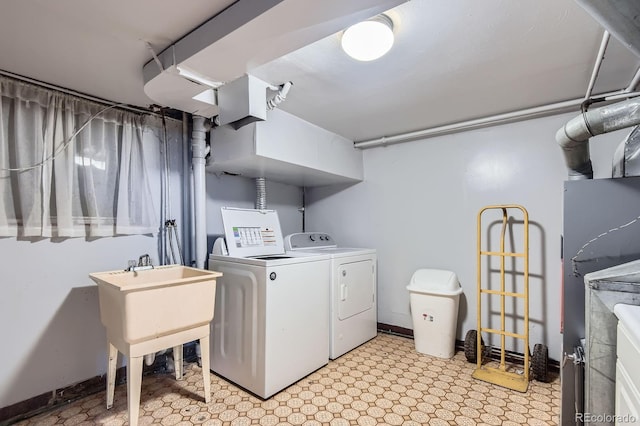 555 W Mansfield Ave, Englewood, CO 80110 - laundry room with washing machine and clothes dryer, light flooring, and baseboards