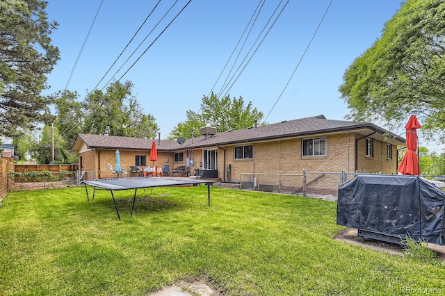 555 W Mansfield Ave, Englewood, CO 80110 - back of property with a trampoline and brick siding