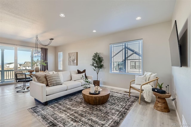 living room featuring light hardwood / wood-style floors and a chandelier