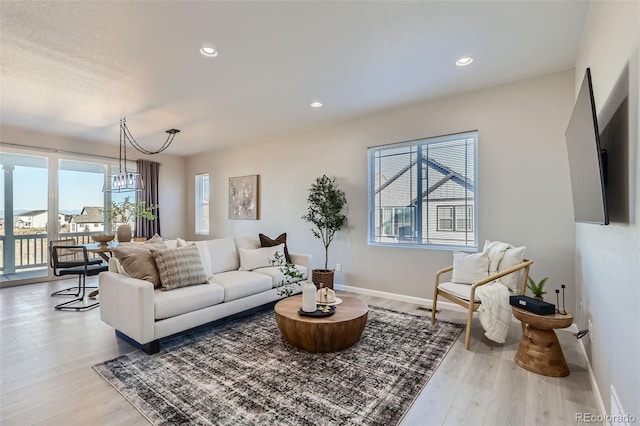 711 N Waterloo Ct, Aurora, CO 80018 - living area featuring wood finished floors, baseboards, and recessed lighting