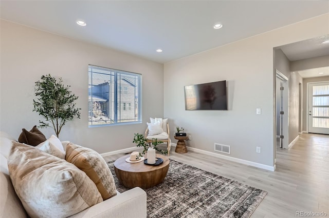 living room with light hardwood / wood-style floors