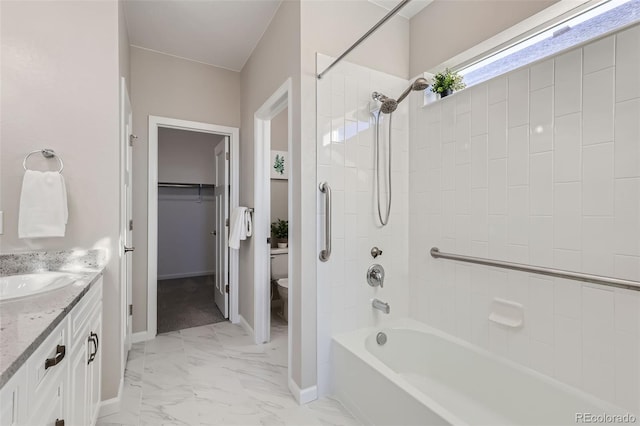 full bathroom with vanity, tiled shower / bath combo, and toilet